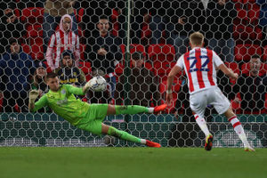 Sam Johnstone of West Bromwich Albion saves a penalty from Tommy Smith (Photo by Adam Fradgley/West Bromwich Albion FC via Getty Images).