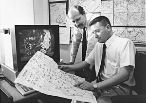 Birmingham Meteorological Office was helping businesses to plan for extremes of weather: The story said: 'One of our clients, a Shropshire (chicken) farmer, started using our service after he suffered tens of thousands of fatalities'. The photograph shows Colin Rutherford (left) and Paul Bridge in February 1991.