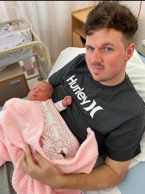 Slimmer Tim Kershaw holding one of his children