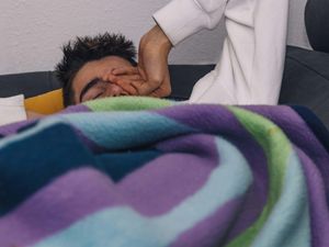 Young teenager waking up sleepy