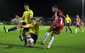 Sean Cooke and Andy Owens of AFC Telford United combine to stop this Curtis McDonald of Brackley Town clearance
