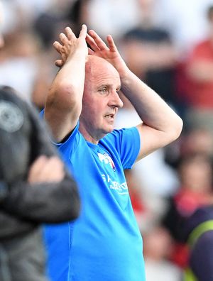 Paul Cook puts his hands on his head as Walsall score a winning goal.