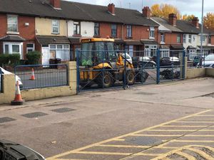 A digger blocks the entrance to J&T Autos on Broad Lanes, Bilston