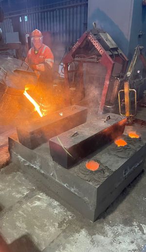 James Mayhew pouring the molten metal for the frames