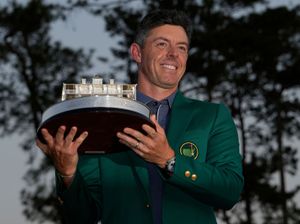 Winner Rory McIlroy, of Northern Ireland, holds the trophy at the Masters golf tournament on April 13