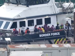 Migrants leaving a Border Force boat after crossing the Channel