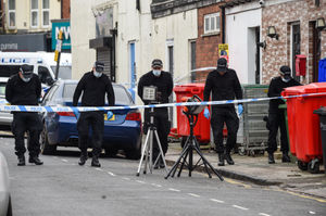 Officers search Poplar Road after the shooting. Photo: SnapperSK