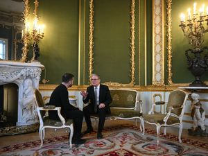 Volodymyr Zelensky and Sir Keir Starmer sitting down talking to each other