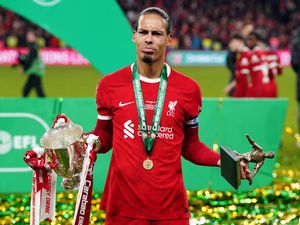 Liverpool captain Virgil van Dijk holds the Carabao Cup and man-of-the-match trophy