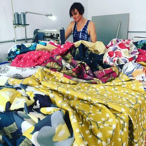 Emma Williams stitches fabric squares together