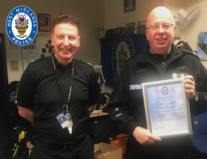 Superintendent Philip Asquith presents Michael with the Good Citizen Award