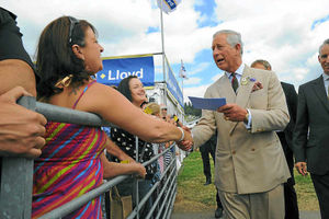 The Prince of Wales receives a card for his newly arrived grandson from Amanda Winney, from Leominster