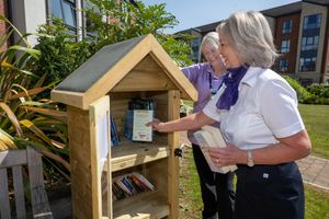 Christine and Maria filling the outdoor library with donated books from the team at Taylor Wimpey North midlands