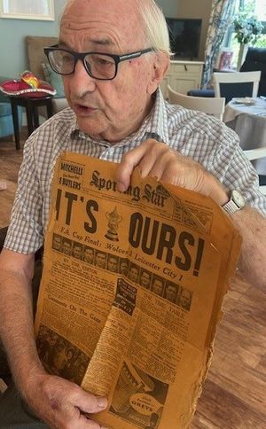 Ray showing old newspaper cuttings from when Wolves won the FA Cup!