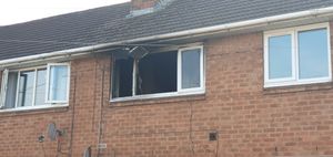 The fire and smoke damage could be seen in the window of the house