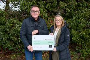 Alex Keller of We Love Lichfield receiving the donation from Elaine Hutchings BEM