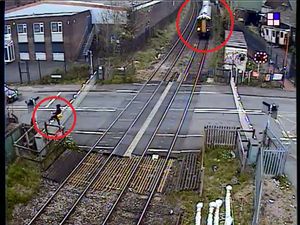 Supporting image for story: Watch: Man casually hops level crossing barrier to walk across railway second before train arrives