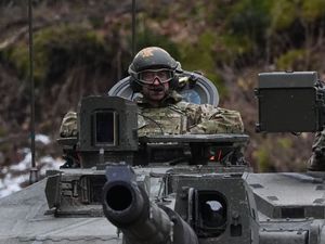 Prince of Wales sitting on top of a tnak