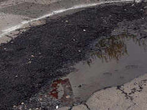Supporting image for story: Half-a-job potholes residents