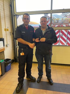 Adam Matthews presenting the long service award to ian Mason. Picture: Shropshire Fire & Rescue Service