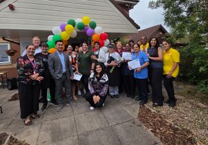 Home Manager Rico Cruz celebrates with team members outside Ryland View Care Home