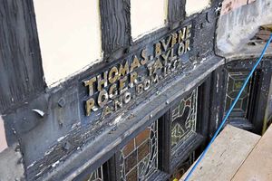 A closer look at a historic plaque on the wall of the building