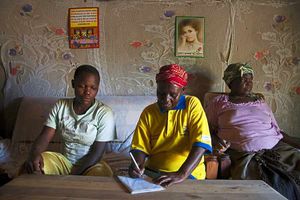 Esther Wasonga on a visit to Elizabeth, who is pregnant, at her home in Siaya County