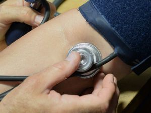 A person has their blood pressure checked