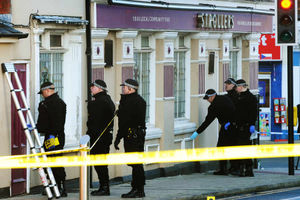 Police at the scene where Carl Campbell was shot, at the junction of Dartmouth Street and High Street, West Bromwich