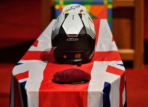 Luke's motocross helmet and beret on top of his coffin.