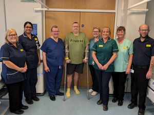 Neil Jones, pictured with staff and his surgeon Ralph Perkins.