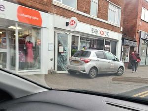 Supporting image for story: Hunt to find group who smashed front door of bank to gain entry