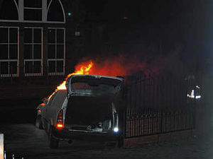 Supporting image for story: Van on fire after hitting school wall