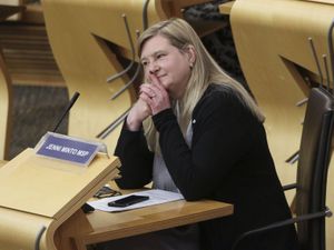 Jenni Minto listening to a debate in Holyrood