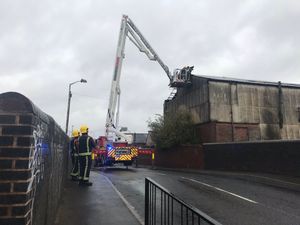 Supporting image for story: Midlands battered by storms as panels loosen from factory roof