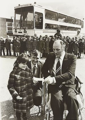 Teachers, parents and pupils at St Thomas More R. C. Primary School, Great Wyrley, raised more money than expected for charity, which went towards a "jumbulance" - a coach converted for taking severely physically disabled people on holidays and trips to Lourdes. The photograph shows Claire Sanderson handing a cheque to Derek Sewell of the Across Trust, in April 1979.