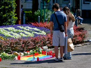 Supporting image for story: German police scour city for knife attacker who killed three at festival