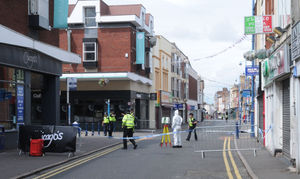 Police teams and forensic officers outside Chicago's after the fatal stabbing