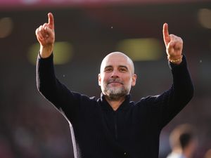 Manchester City manager Pep Guardiola points upwards in celebration following a victory
