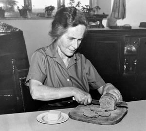 Dora Mayall cuts a slice of the organic bread in 1960.