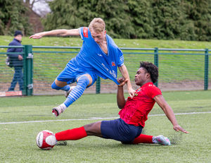 Lichfield City vs St Neots Town Feb 21st 2026. Charlie Footes brought down to earth by Kwadwo Bugyei-Kyei. Pic: Jim Wall