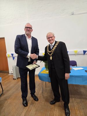 Greg Davies receives his award from Wem's mayor, Councillor David Parry