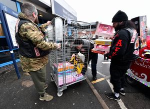 Window cleaner Owen James hands over presents to New Cross Hospital, with help from Santa and the Hells Angels. Photo: Tim Thursfield