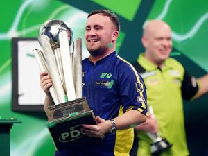 Luke Littler lifts The Sid Waddell Trophy after winning the World Darts Championship final