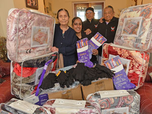 Supporting image for story: Everybody Prosper charity give away blankets, hats and gloves as secret Santa gifts