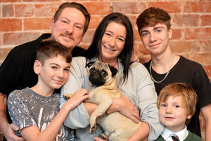 Alastor back in the arms of owner Michelle with her family Nicc, back left, Cameron, Caden and Taylor, bottom right