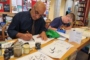 Demostrating Arabic Perisan writting is Sohrab Sdnykian with Jospeh Coates having a go