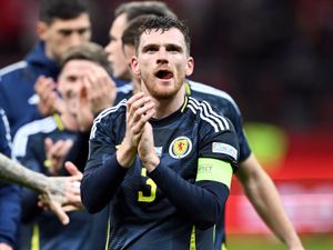 Andy Robertson clapping while wearing the Scotland shirt