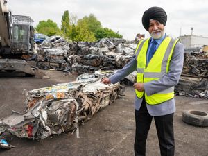 Councillor Bhupinder Gakhal, cabinet member for resident services at Wolverhampton Council, with the crushed van.