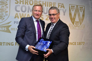 Shropshire FA vice chairman Dave Simpson, right, hands a commemorative gift to Saturday's guest speaker Richard Bevan. Image: Jo Pearce